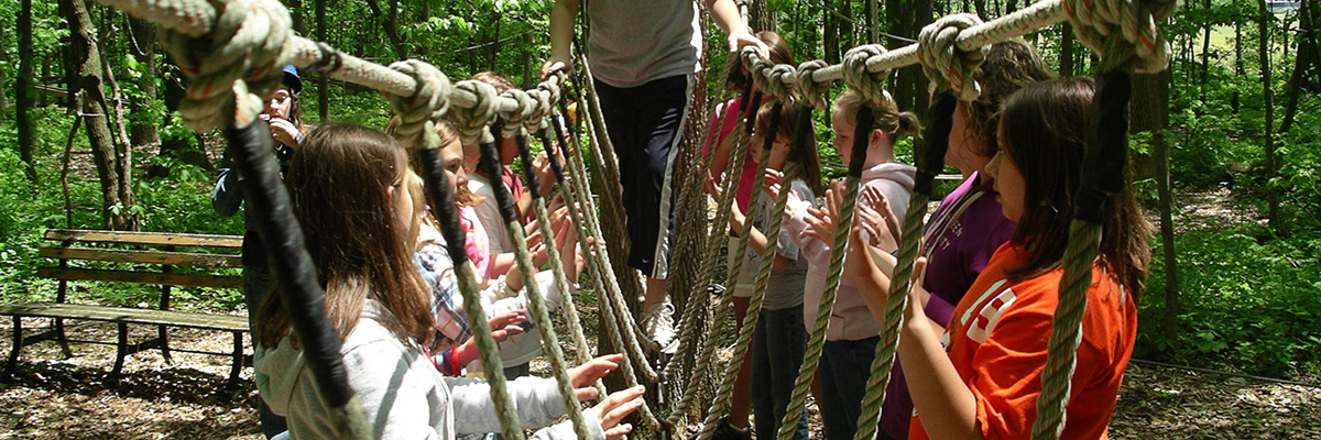 David Graham and an at-risk youth group on a ropes course, empowering confidence.